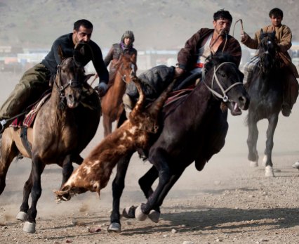JANUARY 21: Afghan horsemen compete in the traditional game of Buzkashi in Kabul, Afghanistan. Buzkashi, which translates to 'goat grabbing,' is the national sport of Afghanistan. During this team sport players try to grab a headless goat carcass from the ground and pitch it into a scoring area. (Majid Saeedi/Getty Images)